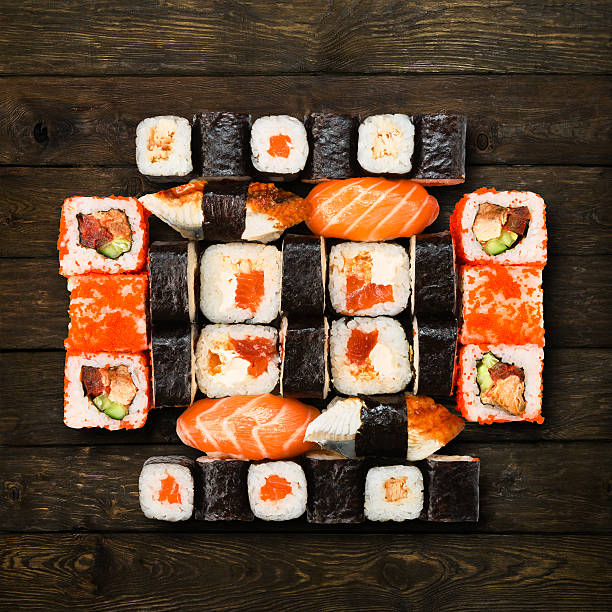 Set of sushi, maki and rolls isolated at wood