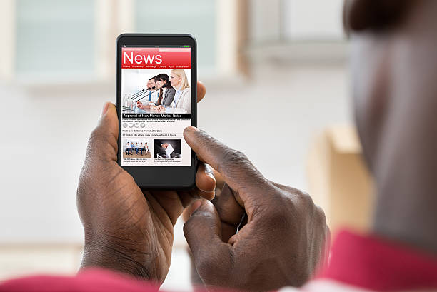 istock African Man Reading News On Cellphone 518431354