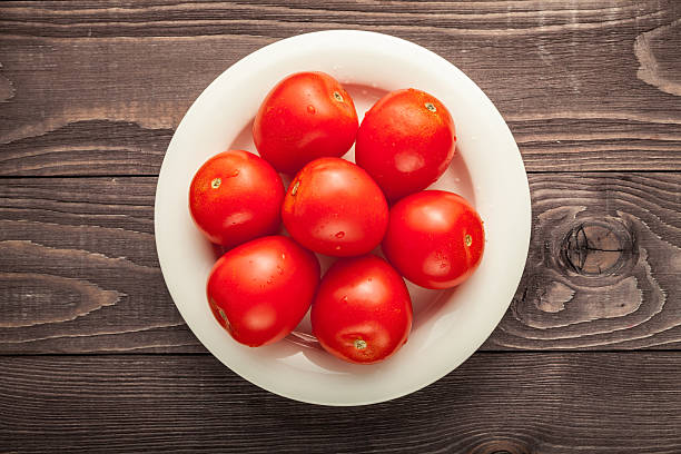 istock plum tomatoes on wooden rustic background 518431498