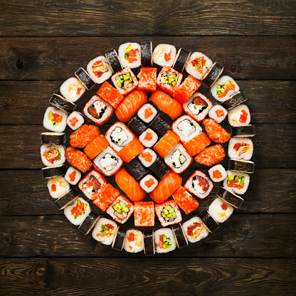 Japanese food restaurant delivery - sushi maki california roll platter set isolated at wooden background, above view