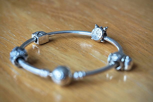 istock Silver bracelet with a collection of symbolic beads 518432184