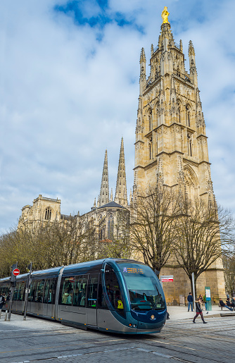 Bordeaux, France - March 26, 2016: ﻿Tram rolling near to Cathedral of St. Andre.﻿Saint Andre is a gothic cathedral of Bordeaux, capital of Aquitaine.