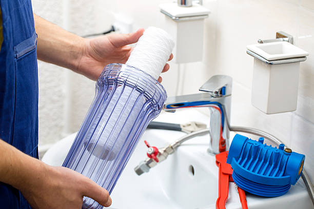 istock plumber installing new water filtration system 518434450