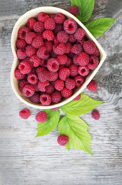 Red raspberry in heart stock photo
