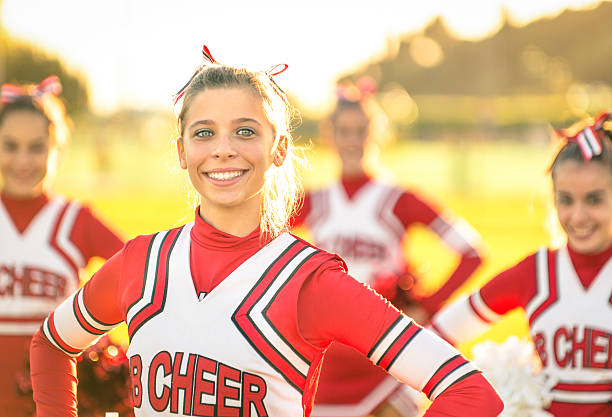 porträt von eine glückliche junge cheerleader in aktion im freien - teenage girls blue eyes adolescence teenager stock-fotos und bilder