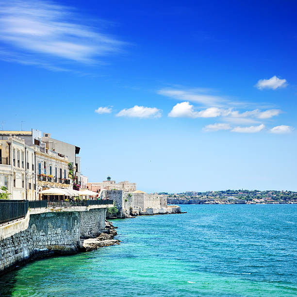 Embankment in Syracuse and the Castello Maniace in the background, Sicily, Italy. Composite photo