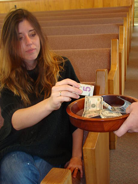 istock Woman making a Church contribution 518457747