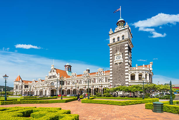 Dunedin railway station, New Zealand Dunedin, New Zealand - November 16, 2014: Dunedin railway station on a sunny day, built 1906 in a revived Flemish renaissance style, Otago Region, New Zealand. dunedin new zealand stock pictures, royalty-free photos & images