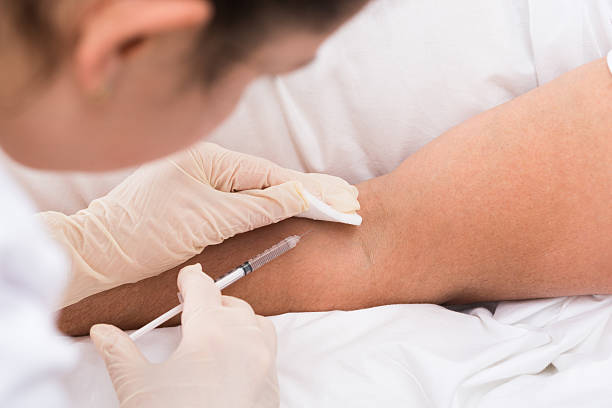 istock Doctor Injecting Vaccine To Patient 518460646