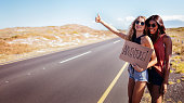 Two Hipster Girls Hitchhiking Together