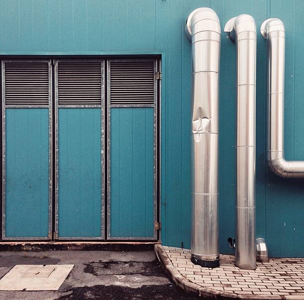 istock Industrial architecture background with ventilation pipes 518464590