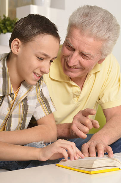 istock Grandfather With Grandson Reading 518464748