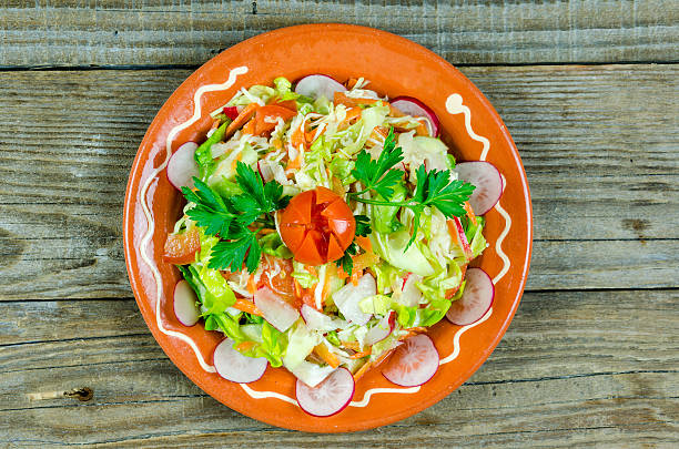 istock Mixed spring salad of vegetables on a  plate 518464908