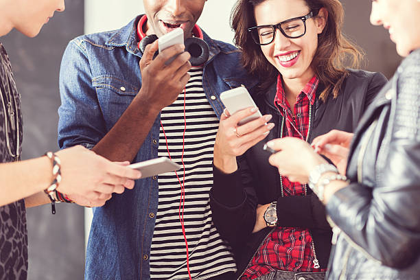 istock Friends using smart phones, close up of hands 518465128