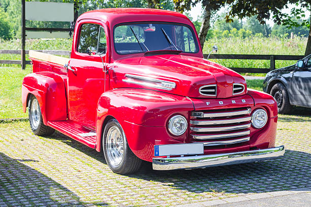 An old renovated red Ford vintage pickup stock photo