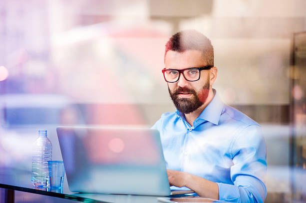 istock Hipster manager in cafe, working on laptop by window 518466130