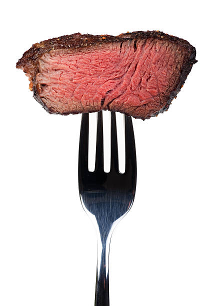 steak on a fork piece of a grilled steak on a fork steak vertical beef meat stock pictures, royalty-free photos & images