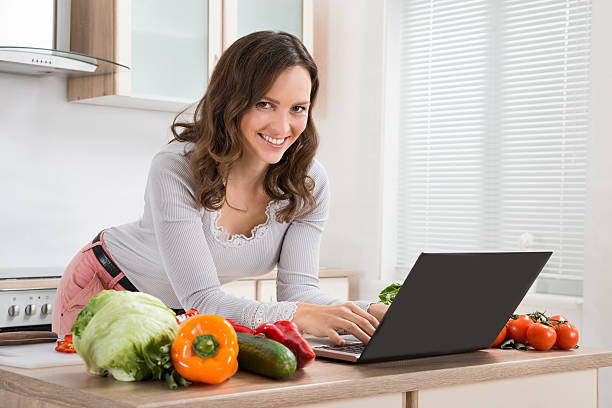 istock Woman Looking Recipe On Laptop 518468686