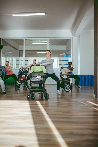istock Mothers Exercise with Their Babies in Gym. 518470176