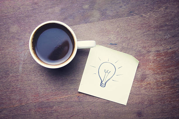 istock bulb on a paper and coffee 518471420