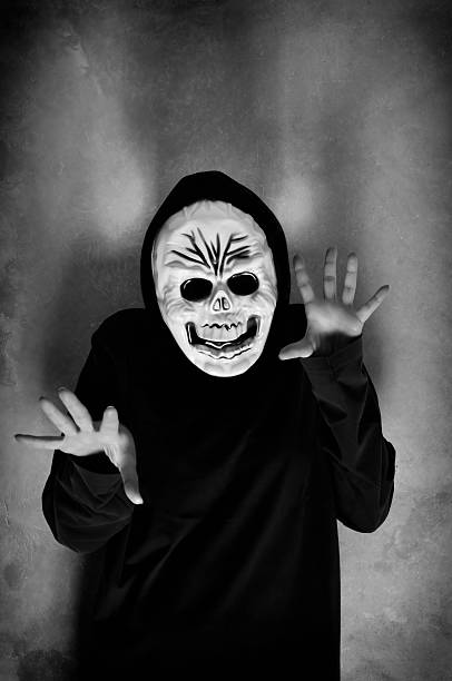 istock Woman with a human skull mask 518471917