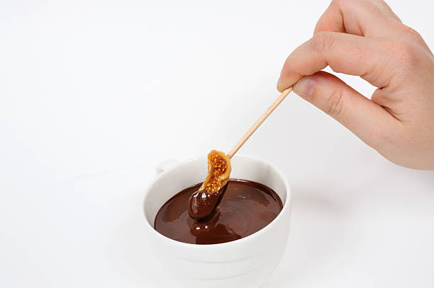 feigen in schokolade zum tunken - dried fig brown color image dried food stock-fotos und bilder