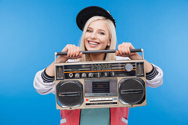 istock Smiling woman holding boom box 518473142