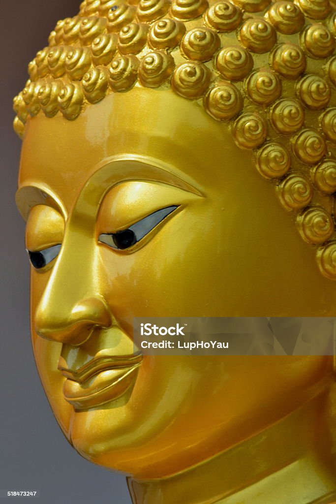Golden Buddha Head Head of a golden Buddha stature shot in Chiangmai, Thailand. Buddha Stock Photo