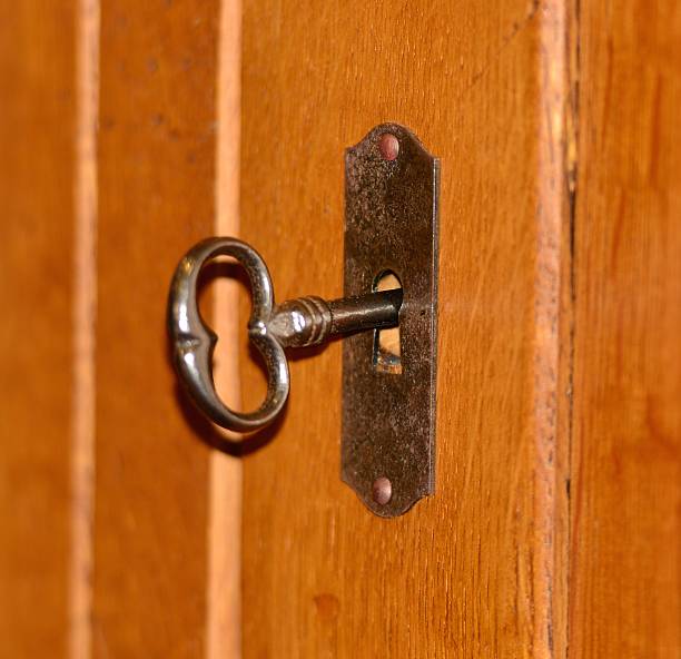 istock Closeup of an old keyhole with key 518473423