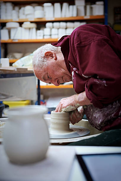 istock Senior man making a clay vase 518482723