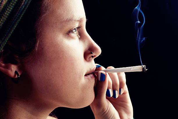 istock Quiet rebel thoughtfullly smoking marjuana cigarette 518483991