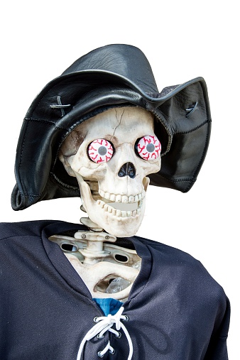 A skeleton with bloodshot eyes wearing a black leather hat and black lace up shirt.