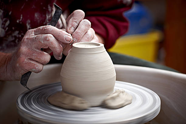 istock Making clay pot on a potter's wheel 518484731