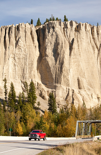 A red truck travelling in British Columbia, Canada.