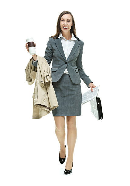 istock Cheerful businesswoman holding coffee cup walking 518485841