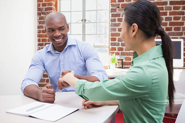 istock Casual business people shaking hands at desk 518486755
