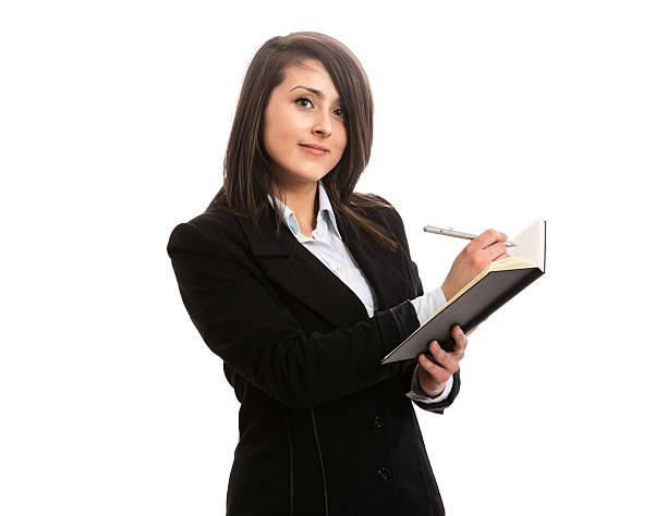 istock Young businesswoman writing in notebook 518487201
