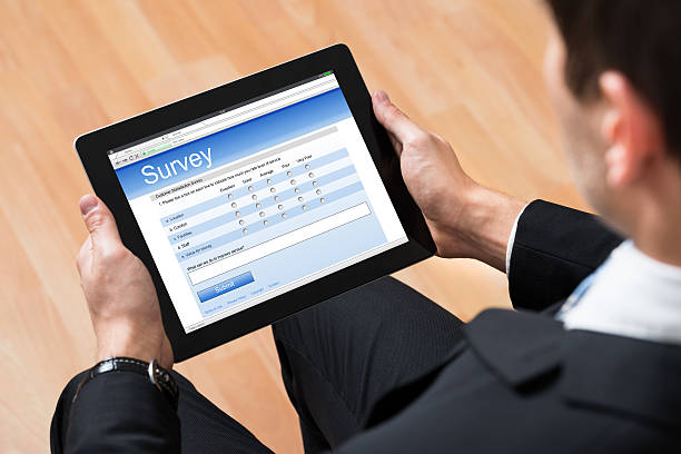 istock Businessman Looking At Online Survey Form 518492674