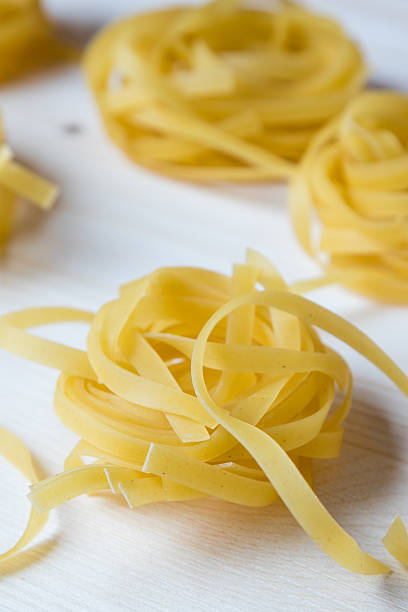 istock tagliatelle pasta on wooden table 518492942
