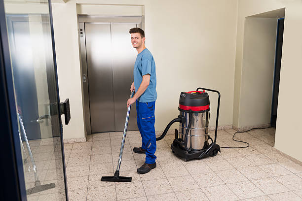 istock Male Worker Cleaning With Vacuum Cleaner 518493034