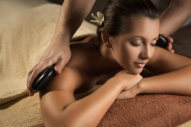 istock Beautiful girl has stone massage. 518493316