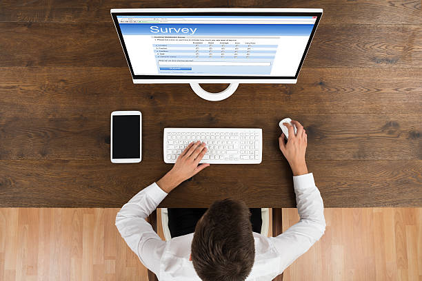 istock Businessman Filling Survey Form On Computer 518493696