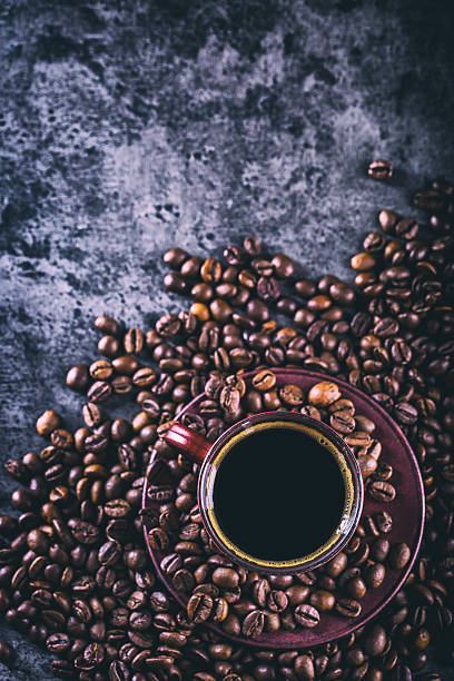 istock Coffee. Cup of black coffee and spilled coffee beans. 518495680