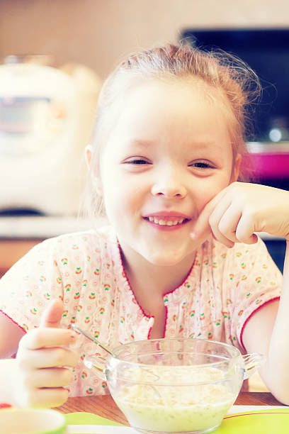 istock Girl having Breakfast in the kitchen 518495842