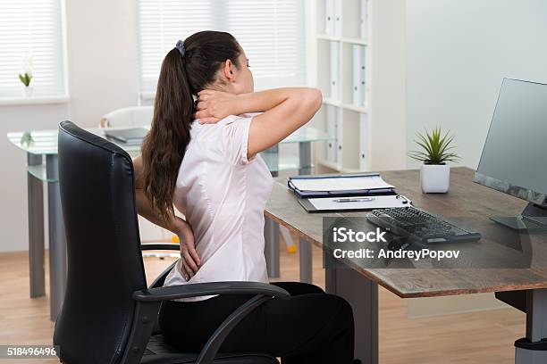 Businesswoman Having Backpain In Office Stock Photo - Download Image Now - Backache, Office, Bad Posture