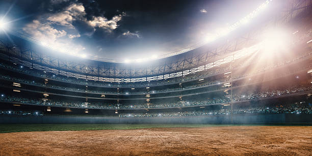 Baseball stadium A wide angle of a outdoor baseball stadium full of spectators under a stormy night sky and rain. The image has depth of field with the focus on the foreground part of the pitch. baseball diamond stock pictures, royalty-free photos & images
