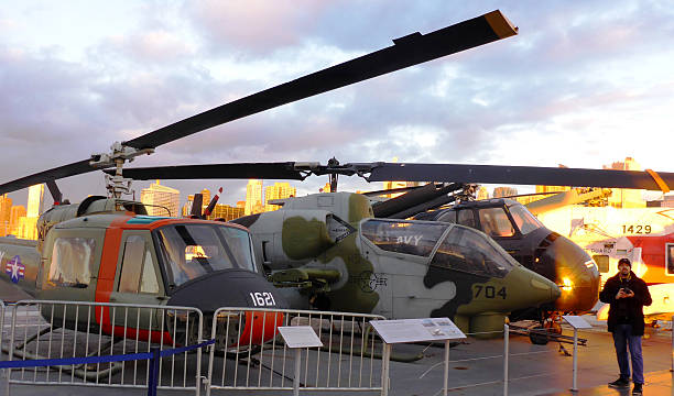 Visit to The Aerospace Museum of NY - The Intrepid New York, USA,  - November 8, 2013: Photographs taken on a visit to the public area of the aerospace museum of New York - The Intrepid. In this image we see the planes and old helicopters exhibited with the City of New York in the background at dusk angung rai museum of art stock pictures, royalty-free photos & images