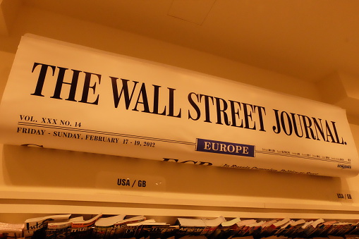 Frankfurt, Germany – March 30th, 2016: The Wall Street Journal's trademark hangs inside a newspaper shop inside the Frankfurt Hauptbahnhof (Train Station)