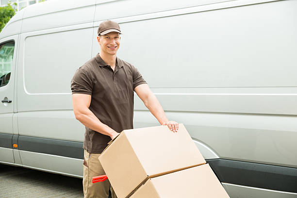 istock Delivery Man Holding Trolley With Cardboard Boxes 518498152
