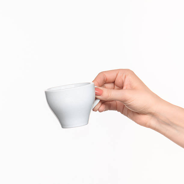 istock Woman hand with cup on white background 518498328